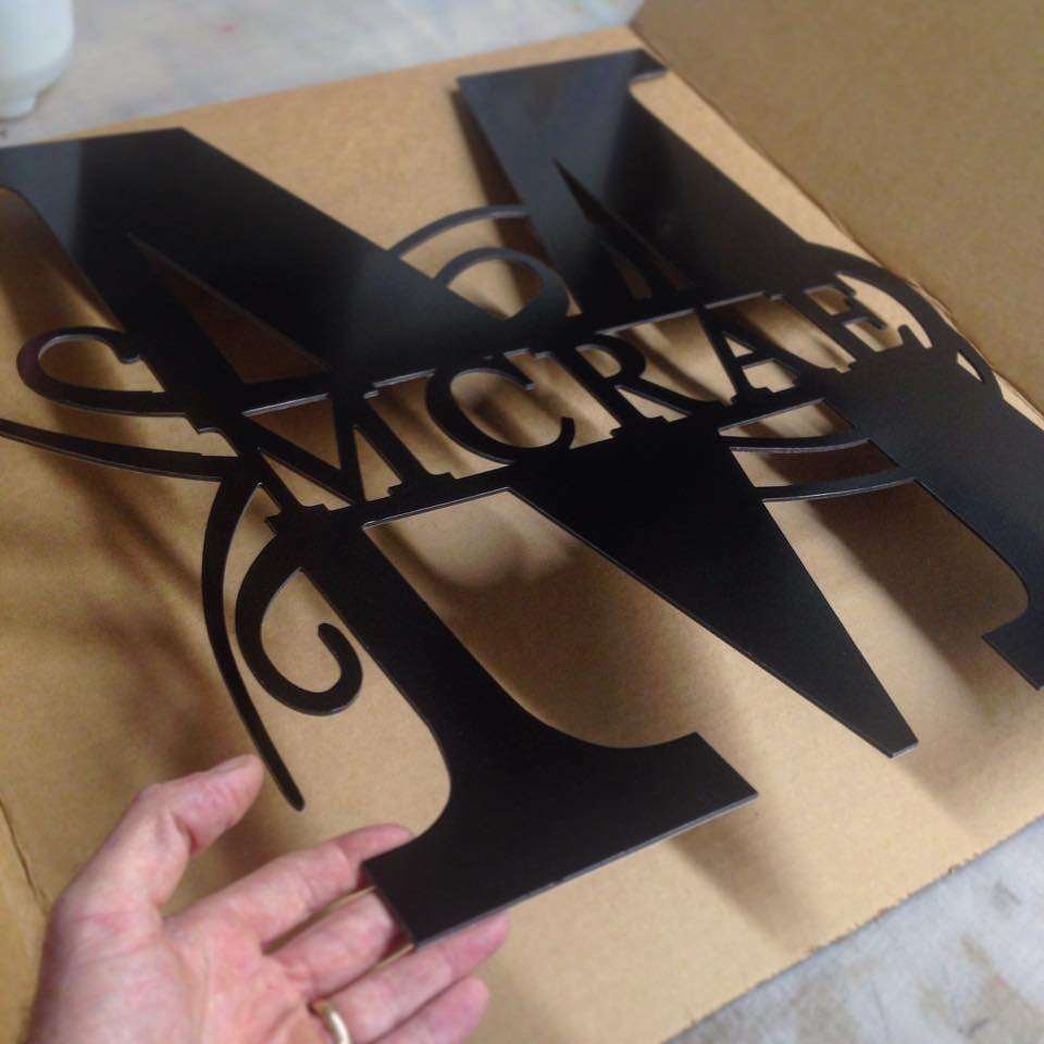 Last Name McRae Letter M sign being packed for shipping.